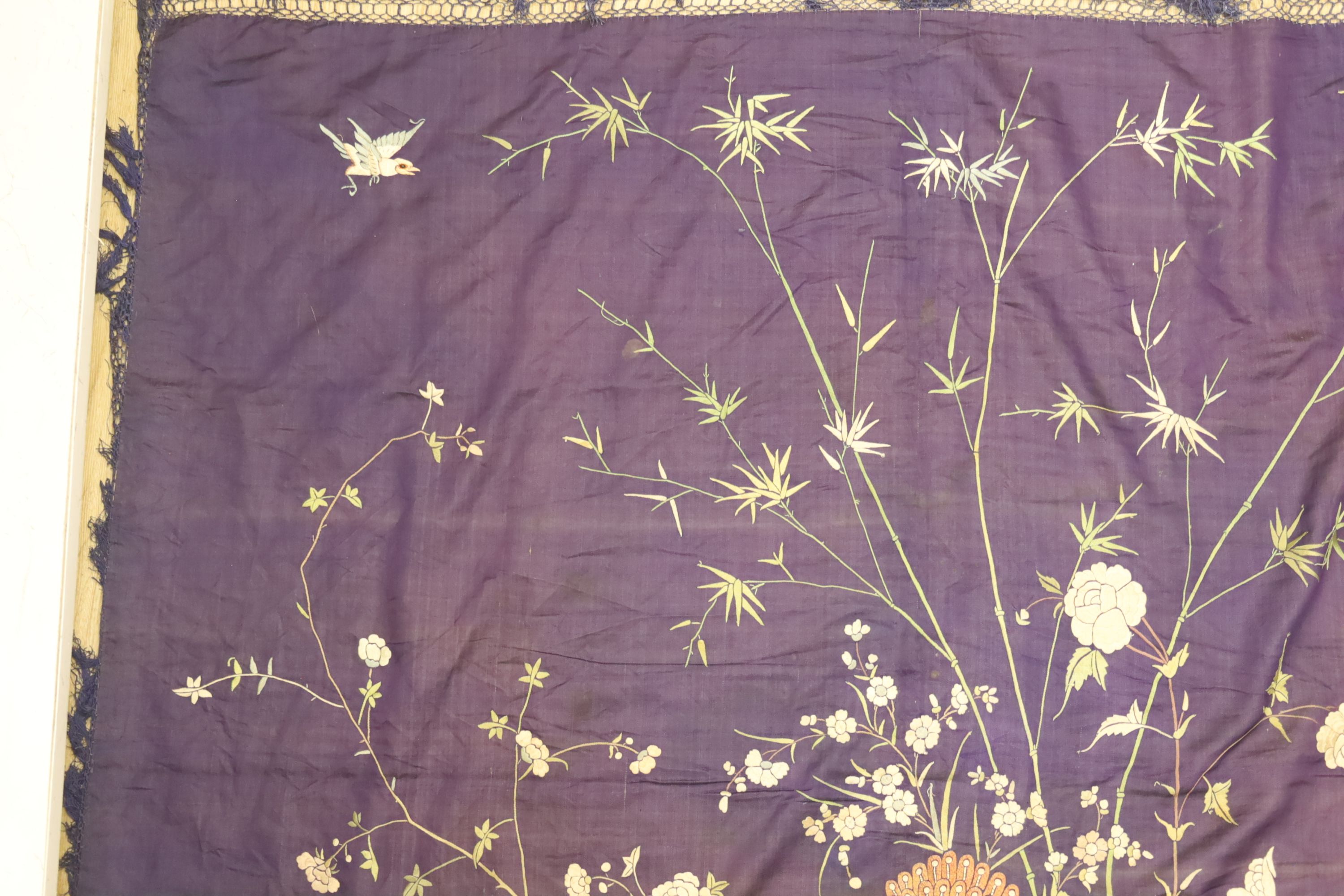 An early 20th century Chinese purple silk embroidered throw edged with trimming, 130 x 134cm